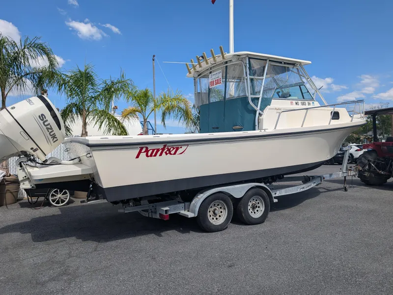 Slide: The Image of 1999 Parker 2510 Walkaround boat on trailer with Suzuki outboard motor. - 8