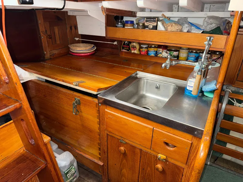 Slide: The Image of Galley of a 1963 Concordia 41 Yawl with wooden cabinets and sink. - 12