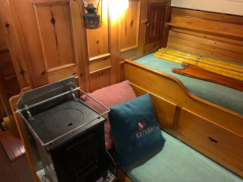 Slide: The Image of Interior of a 1963 Concordia 41 Yawl with wood stove and seating area. - 13