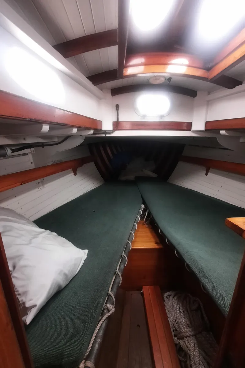 Slide: The Image of Interior of a 1963 Concordia 41 Yawl with green cushions. - 15