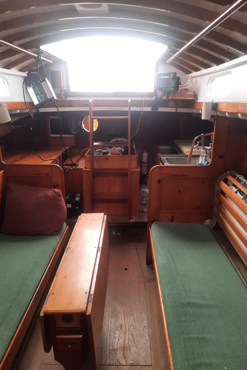Slide: The Image of Interior of a 1963 Concordia 41 Yawl with wooden furnishings. - 16