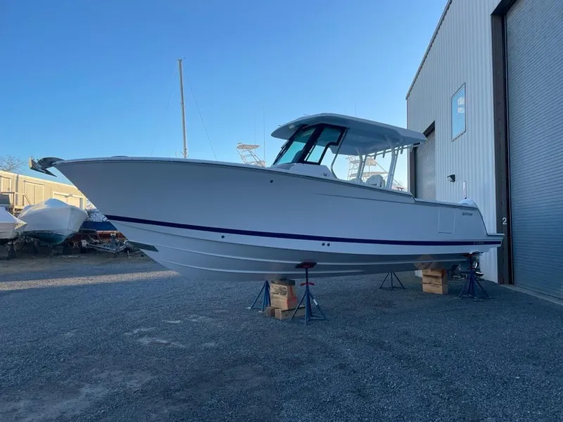 Slide: The Image of 2023 Bertram 28 CC boat on stands outside a storage facility. - 1