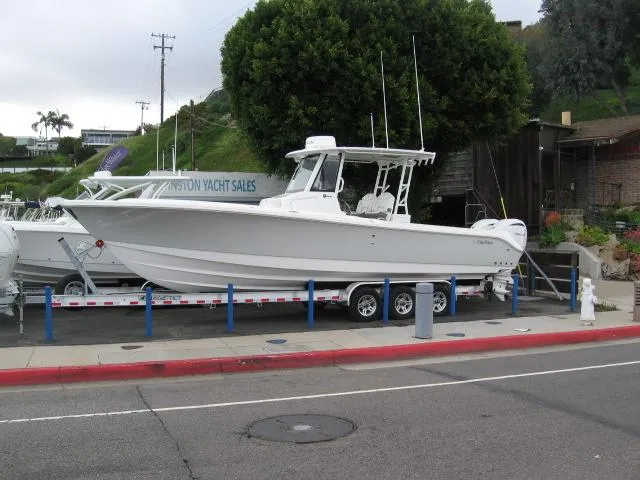 The Image of 2024 Edgewater 325 CC boat on a trailer at a yacht sales lot. - 1