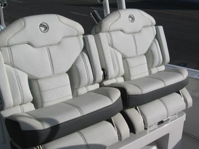Slide: The Image of 2024 Edgewater 325 CC boat seats, white leather upholstery, dual seating. - 10