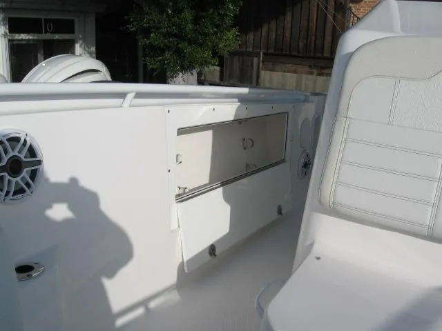 Slide: The Image of 2024 Edgewater 325 CC boat interior with storage compartment and seating. - 6