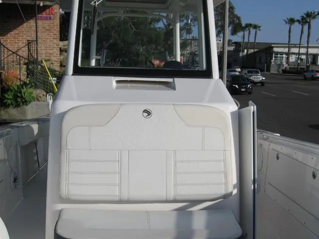 Slide: The Image of 2024 Edgewater 325 CC boat with white seating and console. - 9