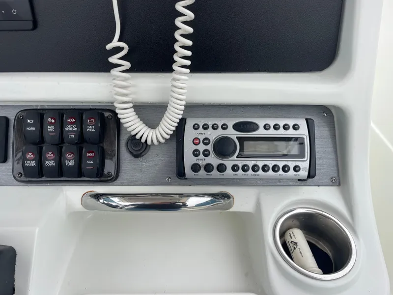 Slide: The Image of Control panel of a 2006 Sailfish 2360 CC boat with radio and switches. - 10