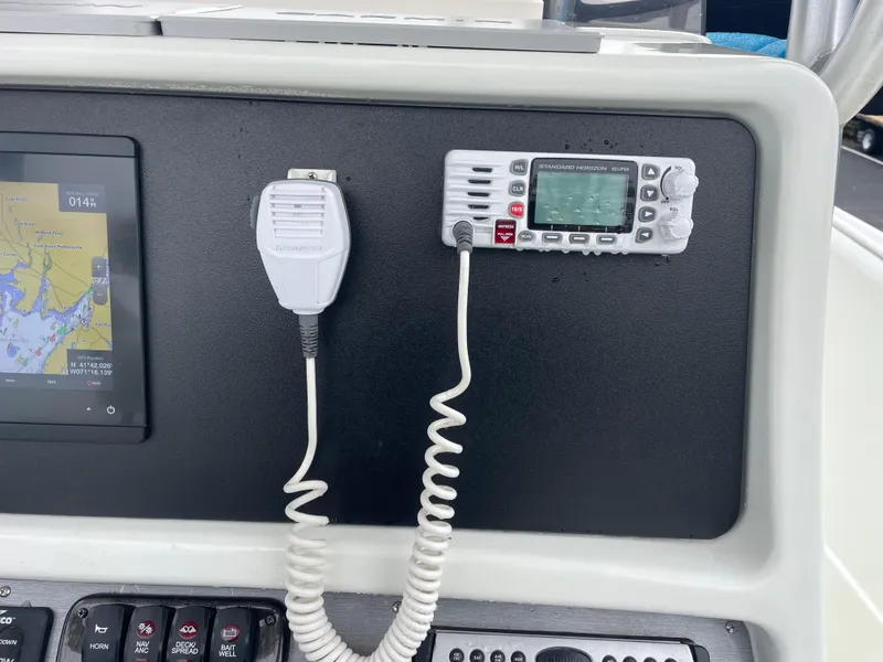 Slide: The Image of Control panel of a 2006 Sailfish 2360 CC boat with navigation and communication equipment. - 11