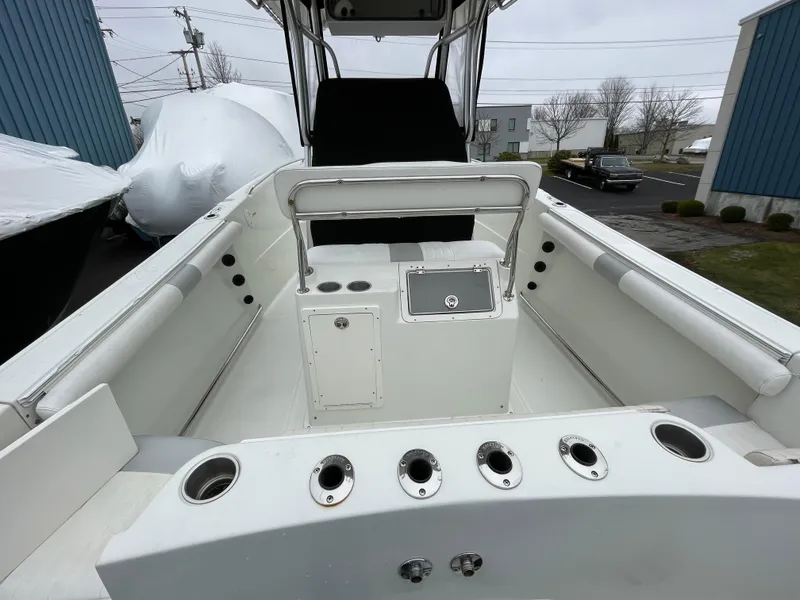 Slide: The Image of 2006 Sailfish 2360 CC center console boat interior with rod holders and storage compartments. - 13