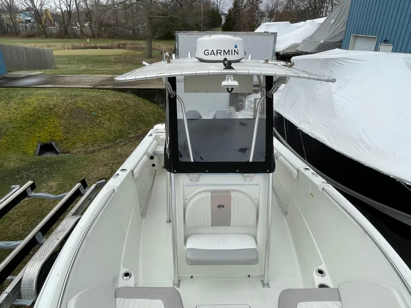 Slide: The Image of 2006 Sailfish 2360 CC boat with Garmin navigation system, docked outdoors. - 16
