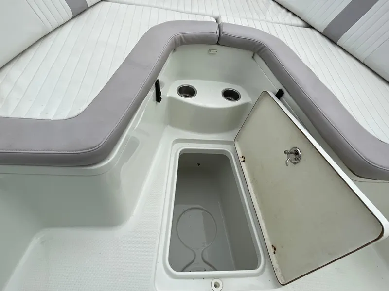 Slide: The Image of 2006 Sailfish 2360 CC boat interior with open storage compartment and cushioned seating. - 17