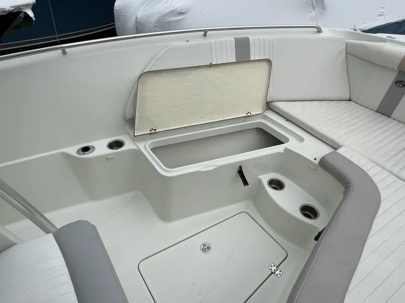 Slide: The Image of 2006 Sailfish 2360 CC boat interior with open storage compartment and seating. - 19