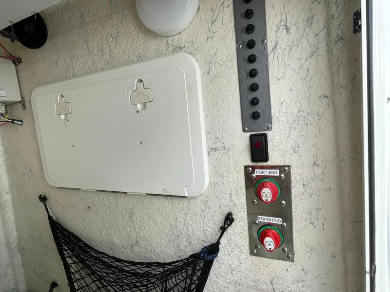 Slide: The Image of Control panel and storage compartment on a 2006 Sailfish 2360 CC boat. - 20