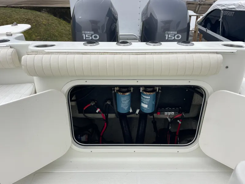 Slide: The Image of 2006 Sailfish 2360 CC boat with Yamaha 150 engines and open storage compartment. - 23