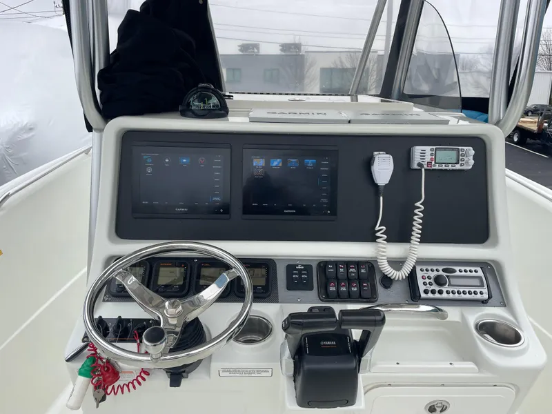 Slide: The Image of 2006 Sailfish 2360 CC boat console with dual screens and navigation equipment. - 7