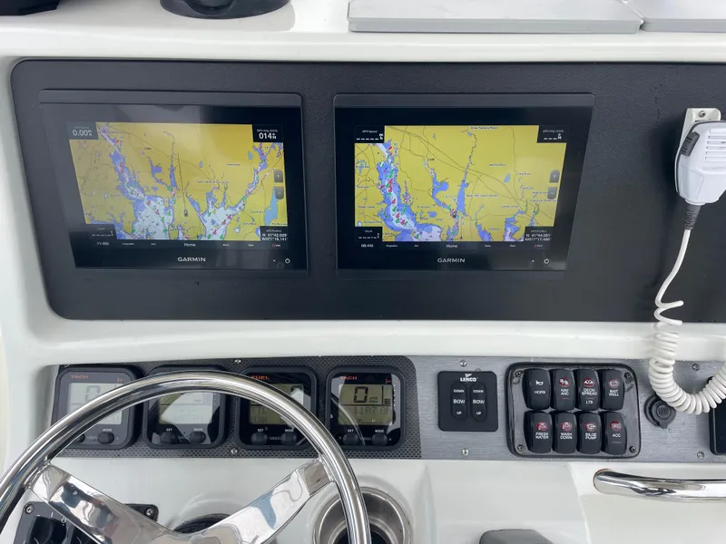 Slide: The Image of 2006 Sailfish 2360 CC boat dashboard with dual Garmin navigation screens. - 8