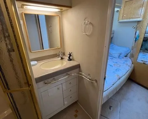 Slide: The Image of 1997 Sea Ray 500 Sundancer bathroom and bedroom interior. - 10