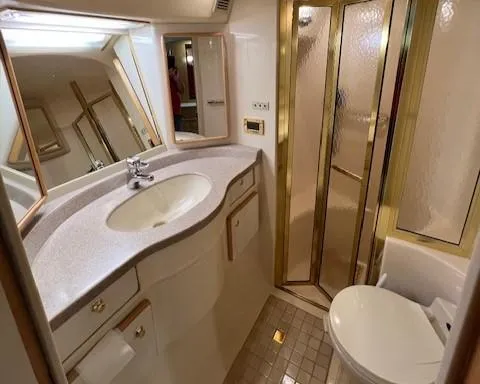 Slide: The Image of 1997 Sea Ray 500 Sundancer bathroom with sink, toilet, and shower. - 11