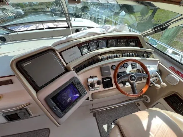Slide: The Image of 1997 Sea Ray 500 Sundancer helm with navigation equipment and wooden steering wheel. - 3