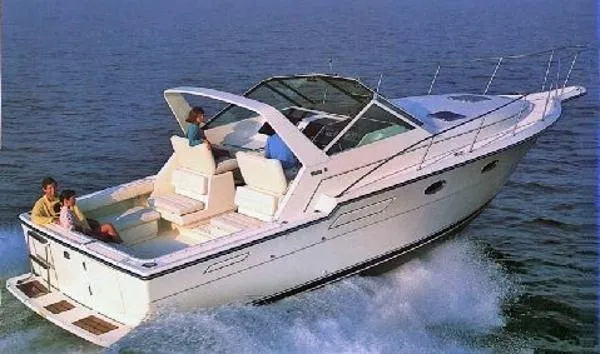 Slide: The Image of 1989 Tiara Yachts 3300 Open cruising on the water with passengers. - 0