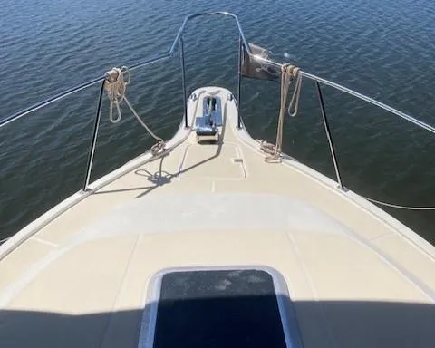 Slide: The Image of 1989 Tiara Yachts 3300 Open bow view on calm water. - 1