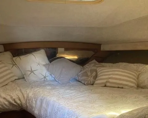 Slide: The Image of Cozy cabin interior of 1989 Tiara Yachts 3300 Open with plush bedding and pillows. - 12