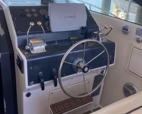 Slide: The Image of 1989 Tiara Yachts 3300 Open helm with Garmin navigation system and dual throttle controls. - 2