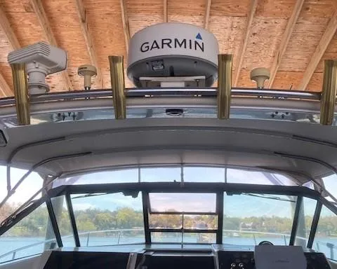 Slide: The Image of 1989 Tiara Yachts 3300 Open with Garmin radar under a wooden roof. - 8