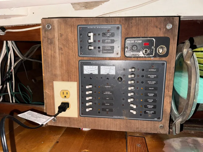 Slide: The Image of Electrical panel on a 1960 Concordia 39 Yawl sailboat, featuring switches and a bilge pump control. - 12
