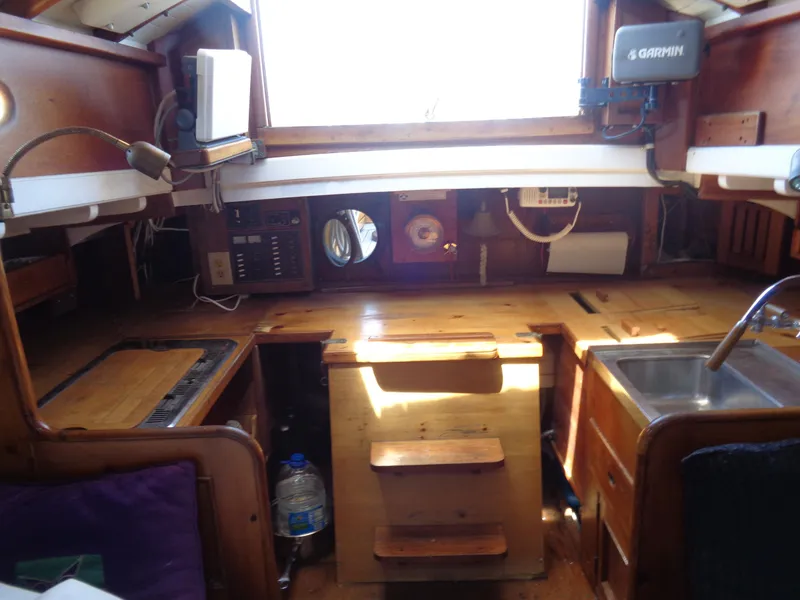 Slide: The Image of Interior of 1960 Concordia 39 Yawl sailboat with wooden cabinetry and navigation equipment. - 2