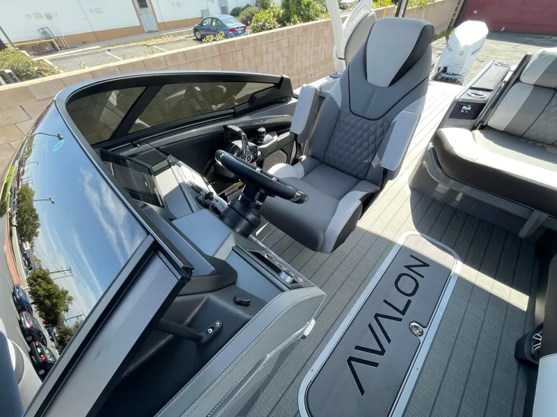 Slide: The Image of 2024 Avalon 2585 EXCALIBUR LTD VRB boat interior with captain's chair and dashboard. - 10