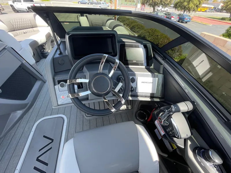 Slide: The Image of 2024 Avalon 2585 EXCALIBUR LTD VRB boat cockpit with modern steering wheel and control panel. - 12