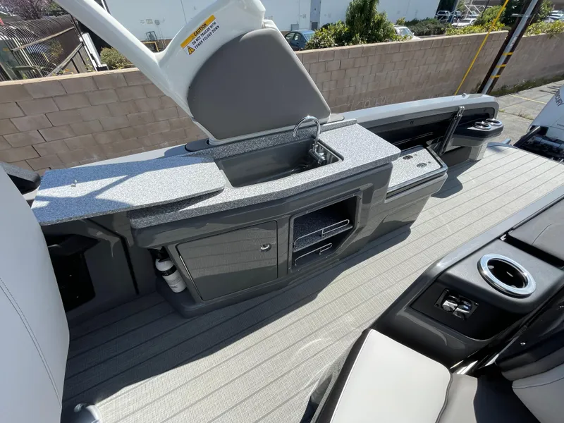 Slide: The Image of 2024 Avalon 2585 EXCALIBUR LTD VRB boat interior with seating and storage compartments. - 14