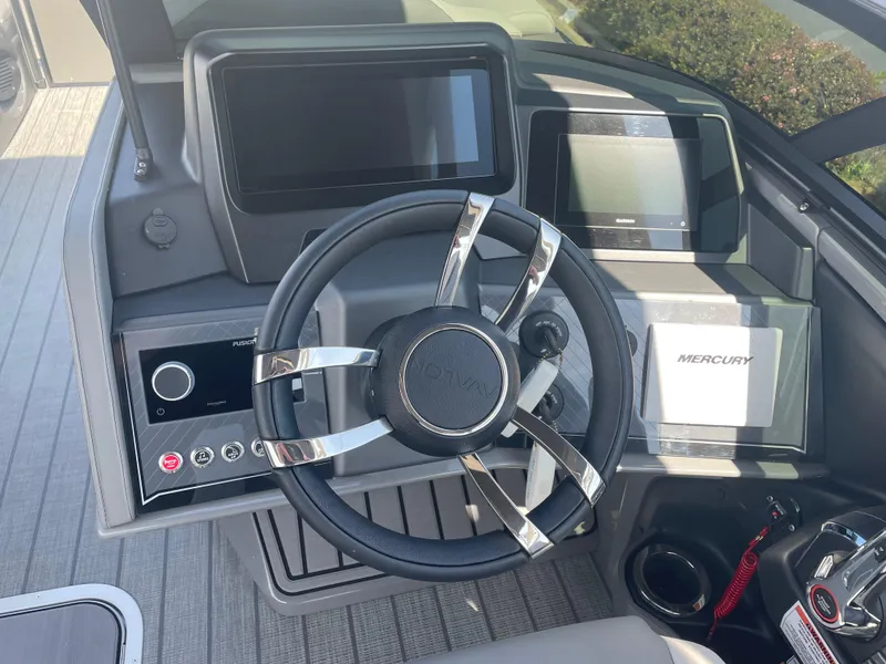 Slide: The Image of 2024 Avalon 2585 EXCALIBUR LTD VRB boat dashboard with steering wheel and control panels. - 17