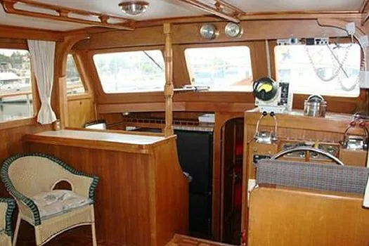 Slide: The Image of 1980 CHB Trawler interior with wooden furnishings and nautical equipment. - 20