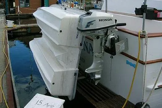 Slide: The Image of 1980 CHB Trawler with Honda outboard motor and docked dinghy. - 3