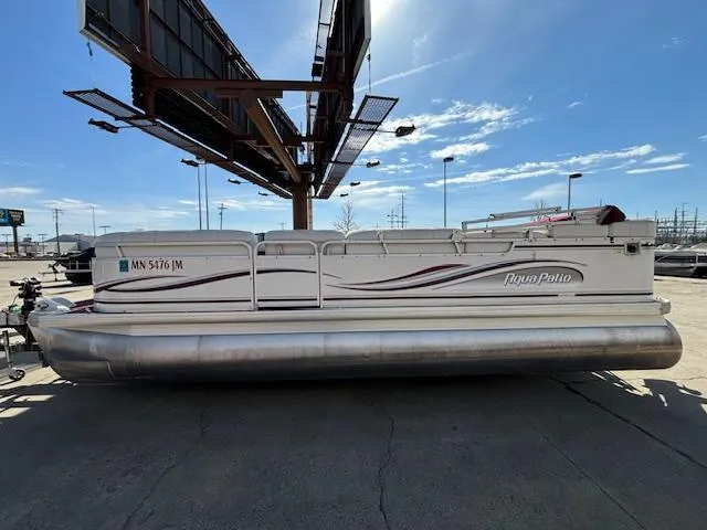 Slide: The Image of 2002 Godfrey Aqua Patio pontoon boat parked under a billboard on a sunny day. - 1