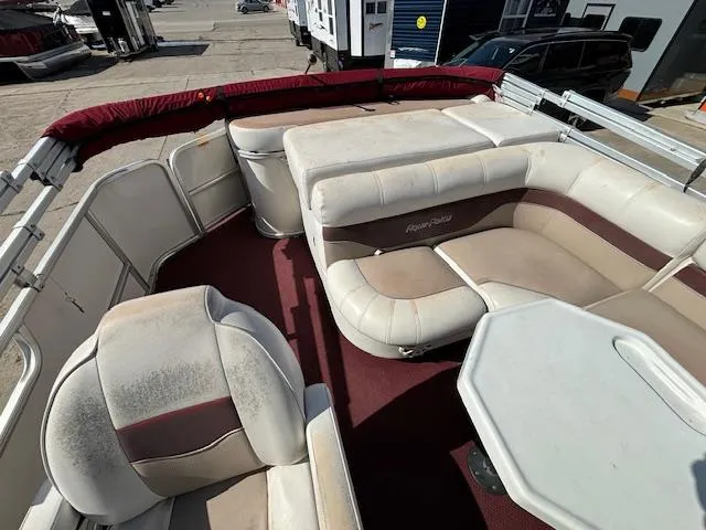 Slide: The Image of 2002 Godfrey Aqua Patio boat interior with white and maroon seating. - 10