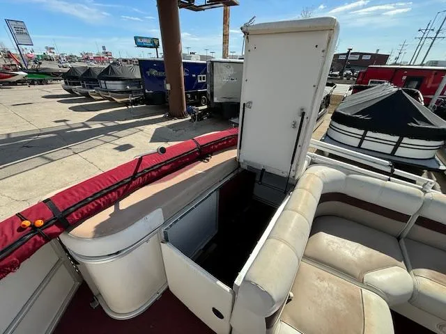 Slide: The Image of 2002 Godfrey Aqua Patio pontoon boat interior with seating and storage compartments. - 12