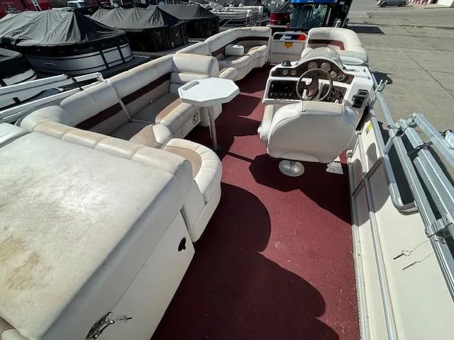 Slide: The Image of 2002 Godfrey Aqua Patio pontoon boat with white seating and red carpet. - 13