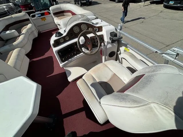 Slide: The Image of 2002 Godfrey Aqua Patio boat interior with white seats and red carpet. - 15