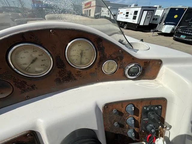 Slide: The Image of 2002 Godfrey Aqua Patio boat dashboard with gauges and controls. - 17