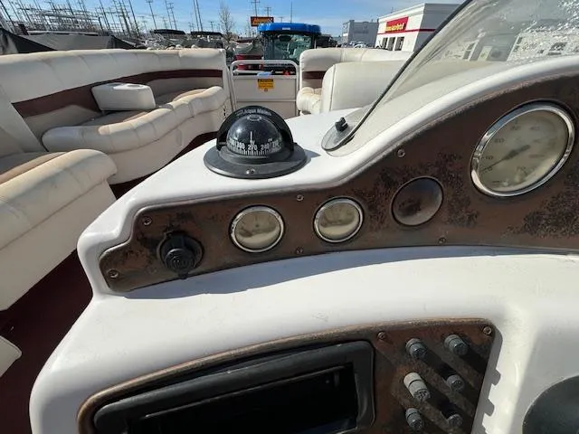 Slide: The Image of 2002 Godfrey Aqua Patio boat dashboard with compass and gauges. - 18