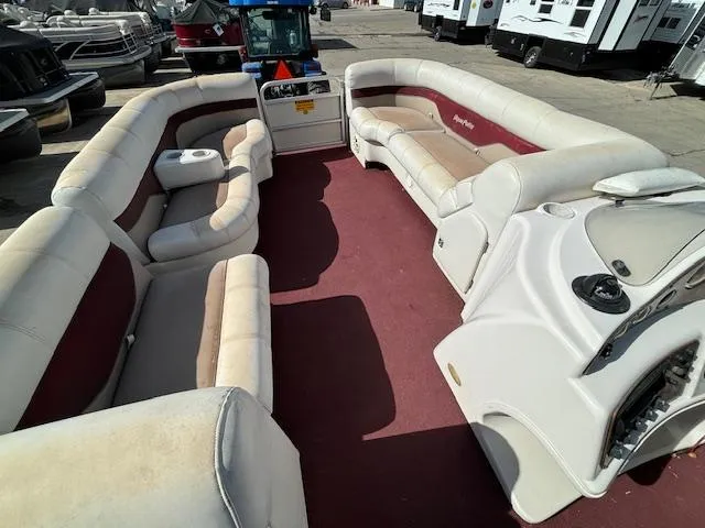 Slide: The Image of 2002 Godfrey Aqua Patio pontoon boat interior with red and white seating. - 20