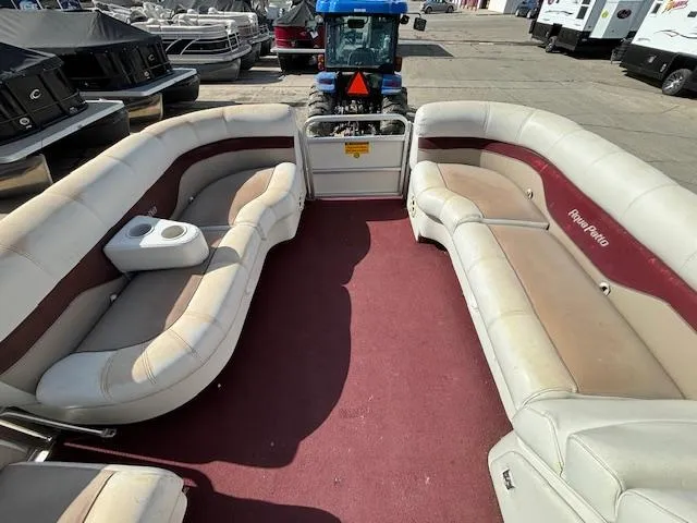 Slide: The Image of 2002 Godfrey Aqua Patio pontoon boat with red carpet and beige seating. - 22
