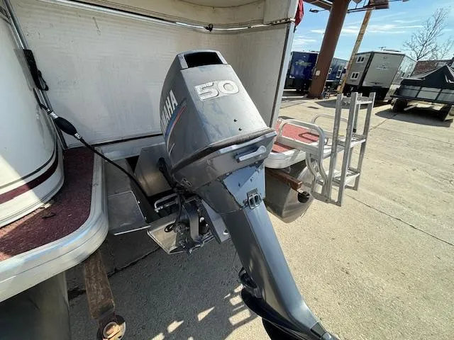 Slide: The Image of 2002 Godfrey Aqua Patio with Yamaha 50 outboard motor in a parking lot. - 3