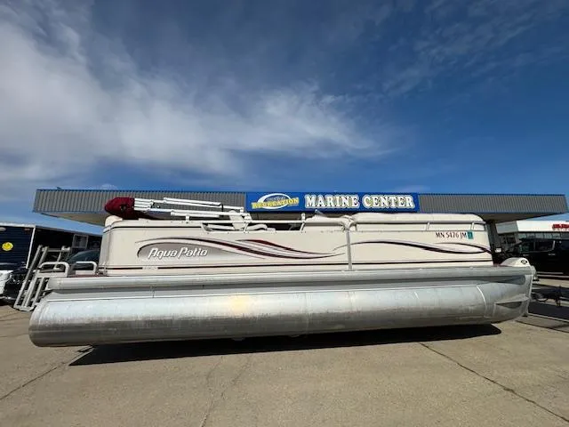 Slide: The Image of 2002 Godfrey Aqua Patio pontoon boat at a marine center. - 4