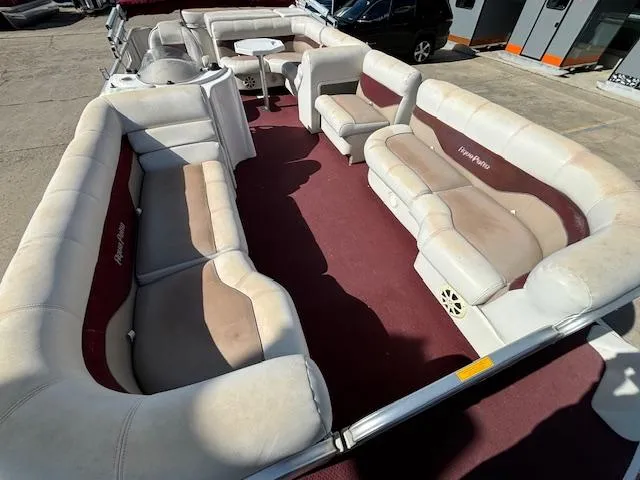 Slide: The Image of 2002 Godfrey Aqua Patio boat with spacious seating and maroon carpet. - 6