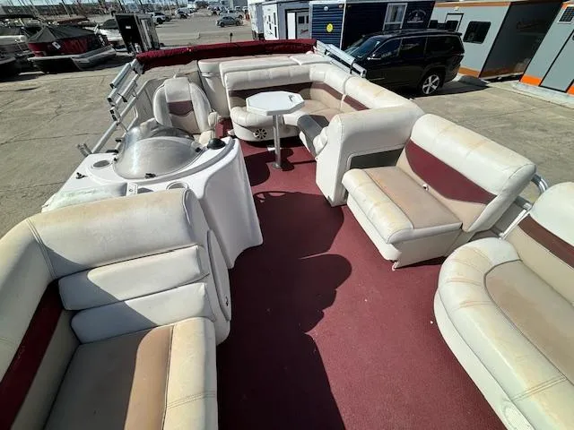 Slide: The Image of 2002 Godfrey Aqua Patio boat with spacious seating and table on deck. - 7