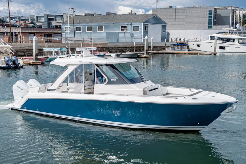 Slide: The Image of 2024 Tiara Yachts 34LS in a marina, side view. - 0
